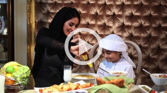 Middle Eastern mother preparing her sons breakfast|