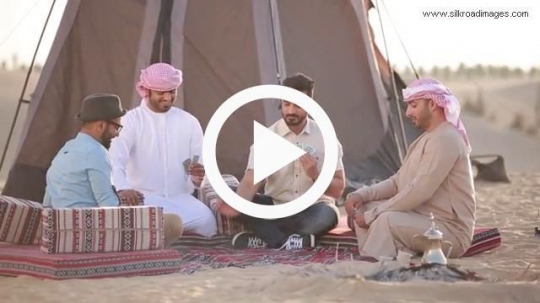 Friends playing cards in wilderness