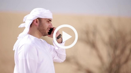 Man making phone call in the desert