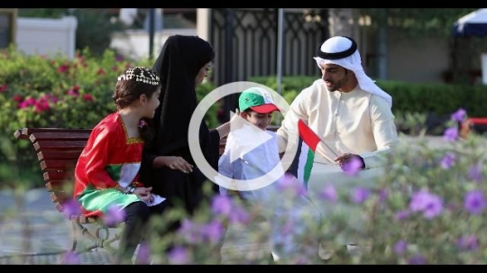 Arab family sitting on the bench representing their country|