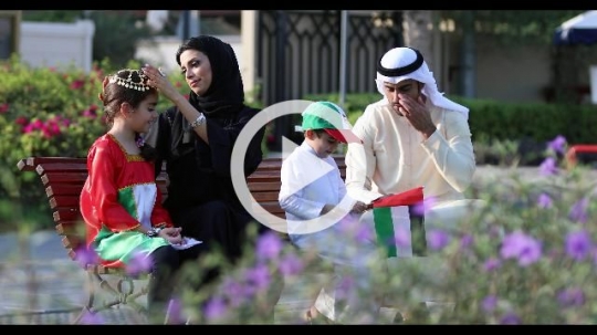 Middle Eastern family sitting on the bench representing their country|