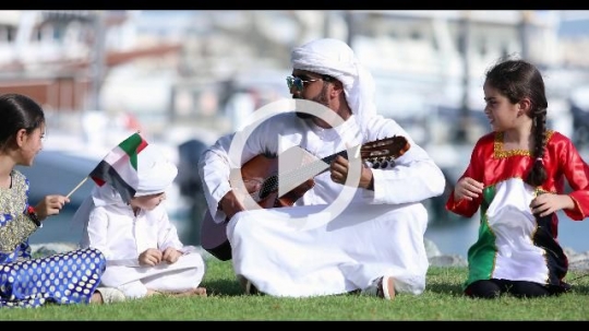 Arab family sitting together celebrating the UAE National Day|