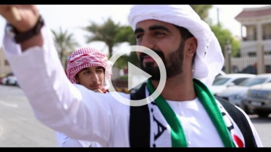 A group of arabs celebrating the UAE National Day during a parade|