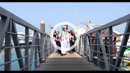 Arabs walking on the dock celebrating the UAE National Day|