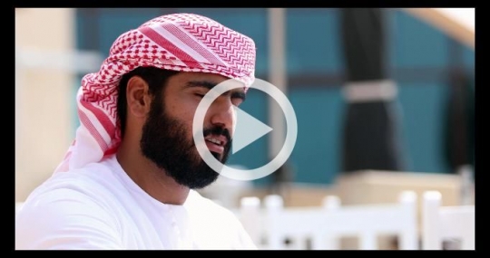 Arab man dressed in the traditional UAE attire talking|