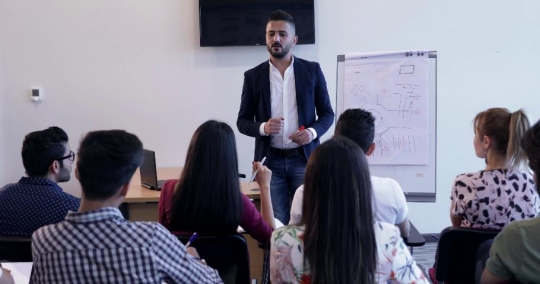 Middle Eastern teacher talking to the students|-