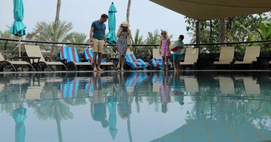 European couple and the kids at the pool|-