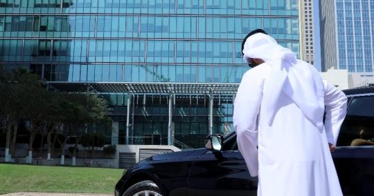 Arab Businessman fixes his kandoura and takes the call|-