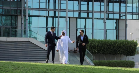 Middle Eastern Businessmen walking with the Western Businessman|-