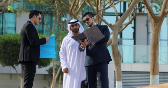 Employees standing talking outside |-