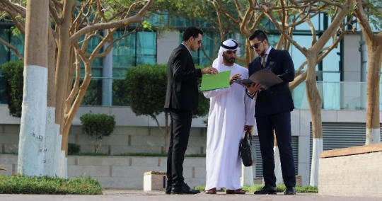 Arab Businessman talking to his colleagues |-