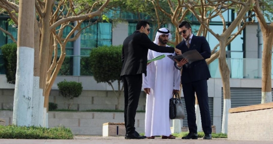 Businessmen standing talking to each other|-