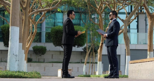 Middle Eastern Businessmen talking to each other |-