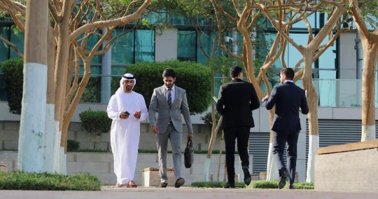 Expat Businessman walking with the Middle Eastern Businessman|-