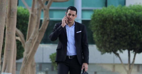 Arab Businessman walking on the phone|-