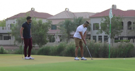 Man playing golf with his friend|-