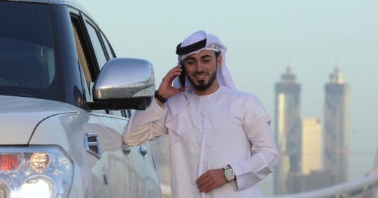 Middle Eastern Businessman talking on the phone|-