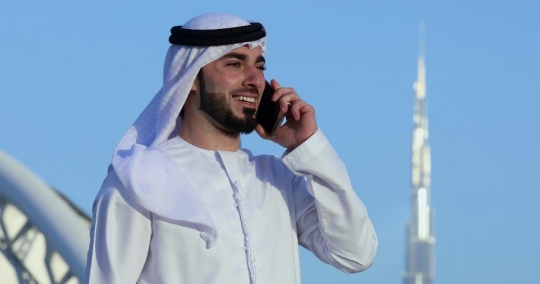 Middle Eastern man talking on the phone|-
