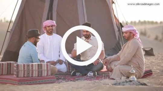 Men playing cards in desert camp