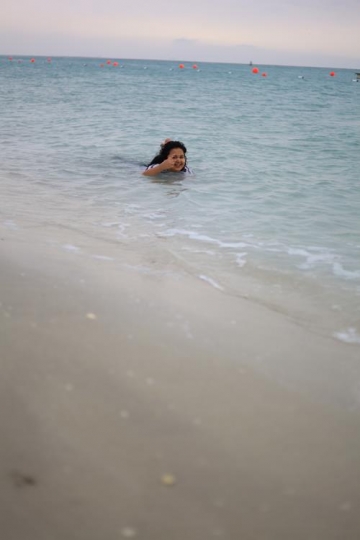 kid swimming by the beach