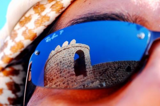 sunglasses close up reflecting an old building