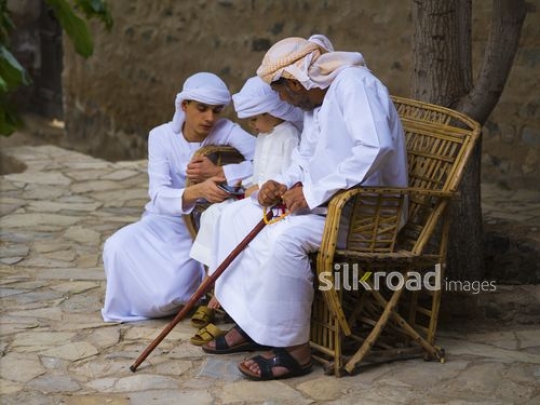 Boys with grandfather on the bench|-