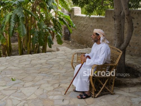 Old man sitting outside|-