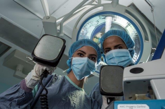 Surgeons Holding Electric Cardioversion Paddles