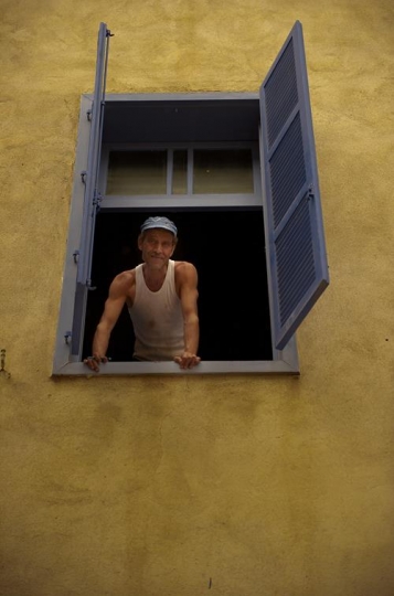 man looking out of windows