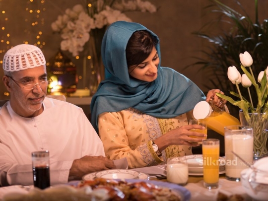 woman pouring orange juice|-