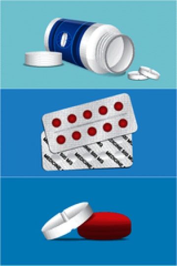 round pills in blister back with pill bottle isolated on blue background