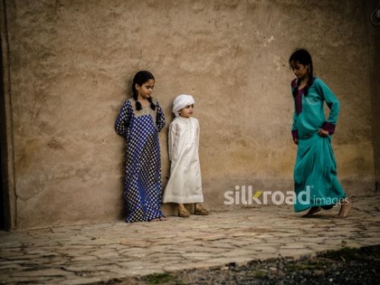 Children playing hopscotch outside|-