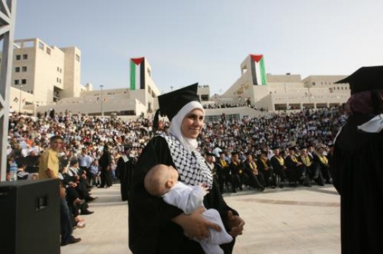 young woman graduate holding b