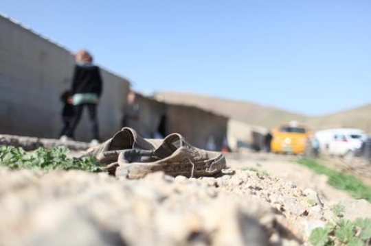 Old shoes for poor boy. Bad life situation.