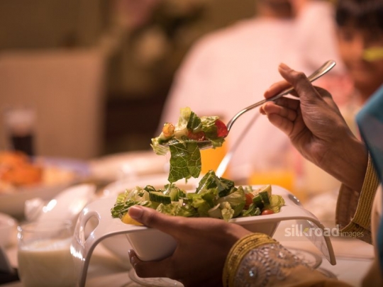 Hand holding oriental salad|-