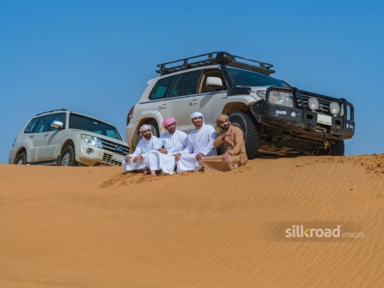 men stopping in the desert