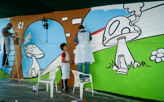group of volunteer painting the wall of kindergarten