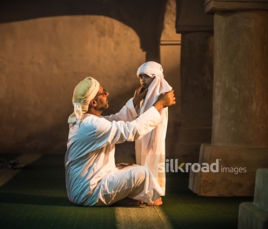 Grandfather with boy at the mosque|-