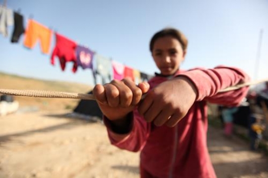 Cute little girl is playing with her brothers.