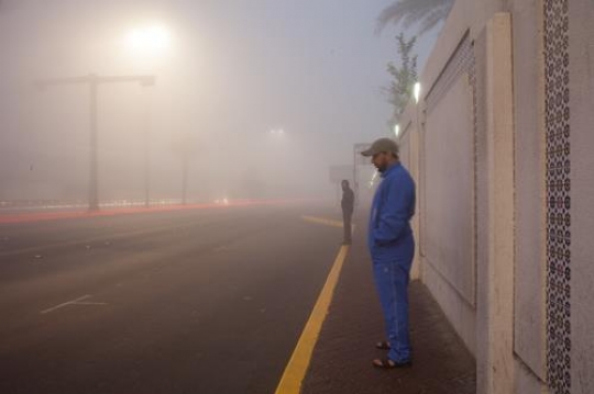 men standing on side walk in fog