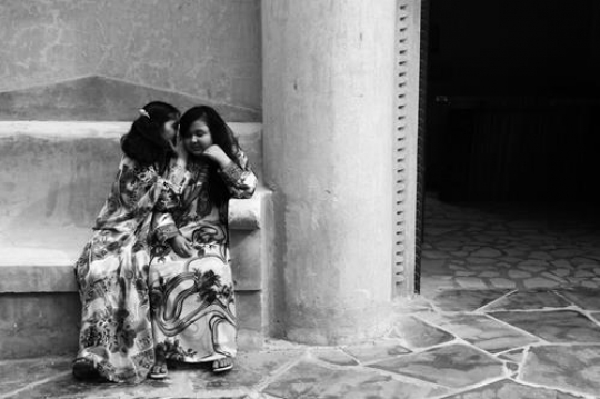 two girls talking wearing local custom