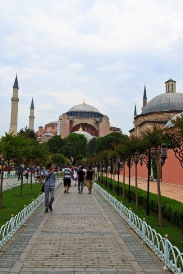 people walking by a mosque