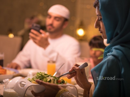 Mother serving oriental salad|-