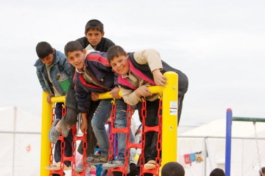 kids play with fairground toys in a camp