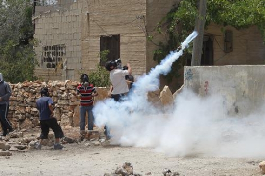 Palestinians throw back Israeli tear gas