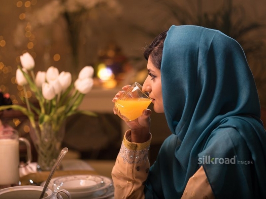 Woman drinking orange juice|-