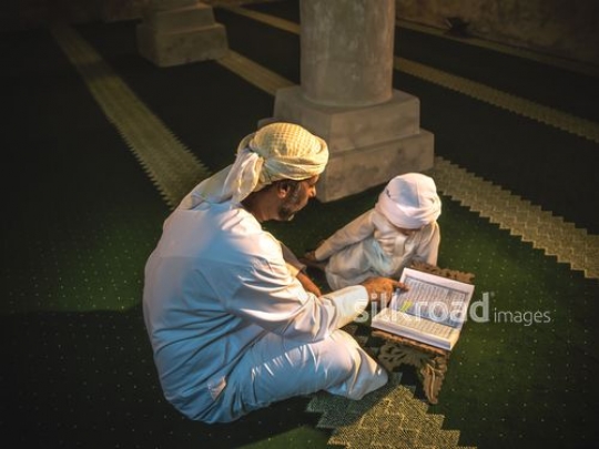 Old man teaching grandson qur'an|-