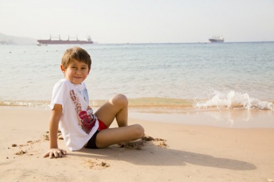 Kid having fun by the beach
