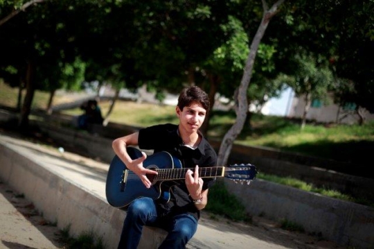 Palestinian Youth Playing Guitar