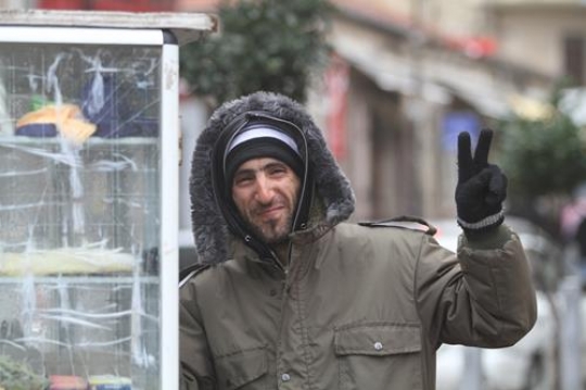 happy man shows peace sign